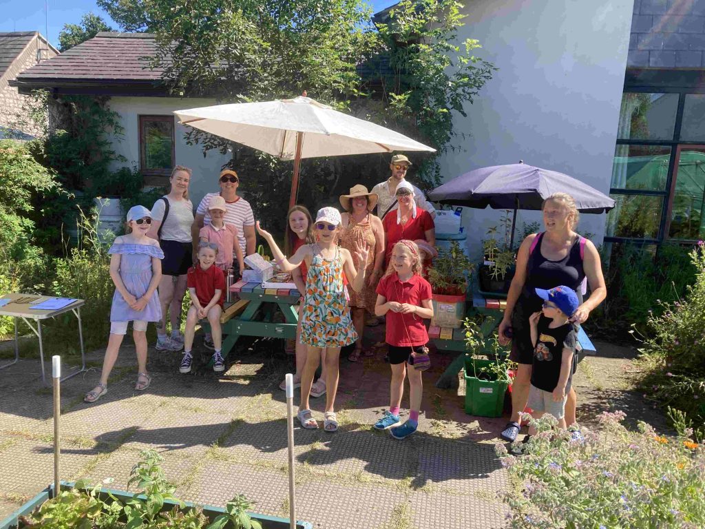 A group of people posing in the sun for the photo after work