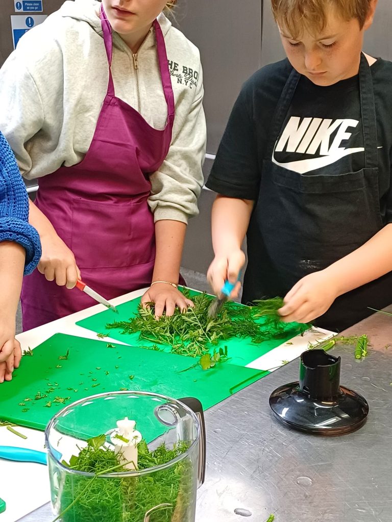 3 children chopping veg